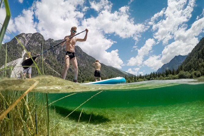 Half Day Stand-up Paddle Boarding (SUP) trip on Lake Predil - Mid-tour beach break: fruit and potato chips in a scenic setting