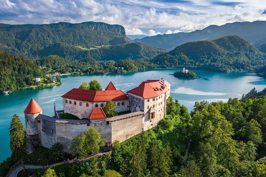 Ljubljana: Lake Bled, Postojna Cave, and Predjama Day Tour - The drive toward Lake Bled and the classic Pletna boat to Bled Island